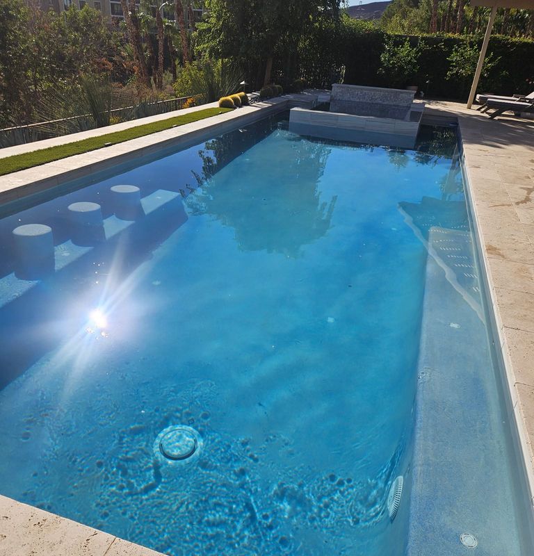 A clean, clear blue backyard pool in Las Vegas after weekly service by Palm Springs Pools